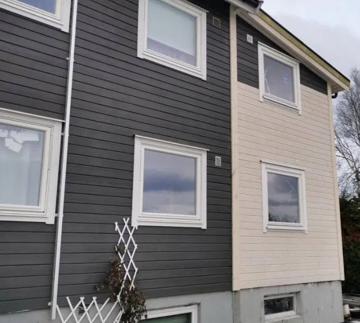 Bolig med mørk kledning og nytt ubehandlet kledningsfelt
